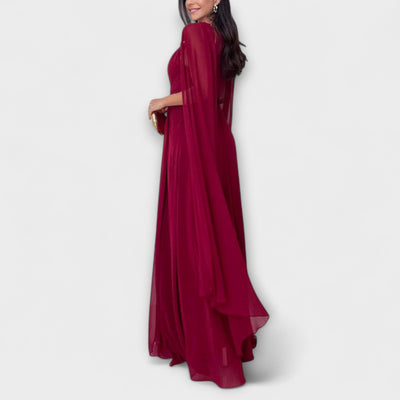 Mabel - Elegantes Maxikleid mit Cape-Ärmeln und hohem Schlitz" 

Rewritten: "Mabel - Stilvolles Maxikleid mit schwingenden Cape-Ärmeln und verführerischem Schlitz